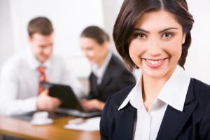 Image of attractive woman with charming smile on the background of business people