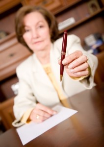 business woman offering her pen to seal the deal