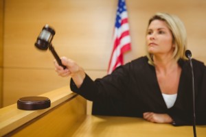 Judge about to bang gavel on sounding block in the court room