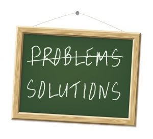 A chalk board with the words problems and solutions