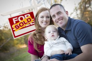 stockfresh_1676251_happy-young-family-in-front-of-sold-real-estate-sign_sizeS-300x200