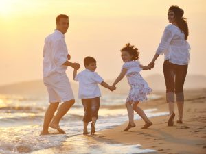 stockfresh_1018858_happy-young-family-have-fun-on-beach-at-sunset_sizeS-300x225