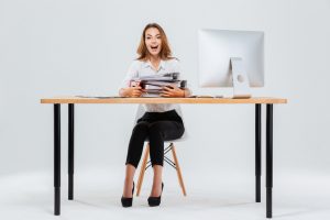 stockfresh_7381684_surprised-happy-young-businesswoman-sitting-at-the-table-with-pc_sizeS_d1c148-300x200