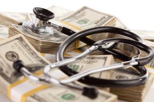 stockfresh_636353_stethoscope-laying-on-stacks-of-money_sizeS-300x200