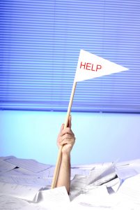 stockfresh_356578_hand-with-help-flag-sticking-out-of-papers_sizeL-201x300
