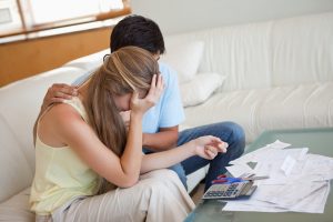 stockfresh_2581878_sad-couple-in-financial-trouble-in-their-living-room_sizeS-300x200
