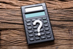 stockfresh_8413825_closeup-of-question-mark-and-calculator-on-wood_sizeS-300x200