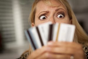 stockfresh_1211123_upset-woman-glaring-at-her-many-credit-cards_sizeS-300x200