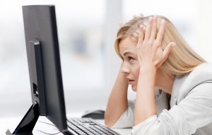 Woman stressed at the computer screen